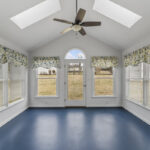 Sun porch on the rear of the home leading to a small patio area.